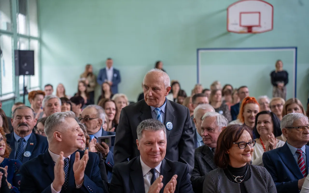 Występ artystyczny uczniów podczas oficjalnej akademii z okazji 110-lecia SP 2 w Skierniewicach, na scenie baner jubileuszowy.