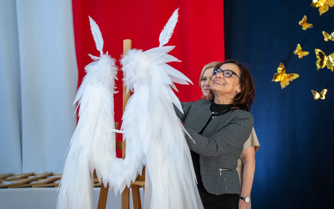 Występ artystyczny uczniów podczas oficjalnej akademii z okazji 110-lecia SP 2 w Skierniewicach, na scenie baner jubileuszowy.
