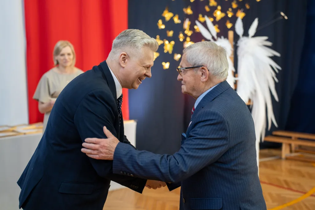 Występ artystyczny uczniów podczas oficjalnej akademii z okazji 110-lecia SP 2 w Skierniewicach, na scenie baner jubileuszowy.