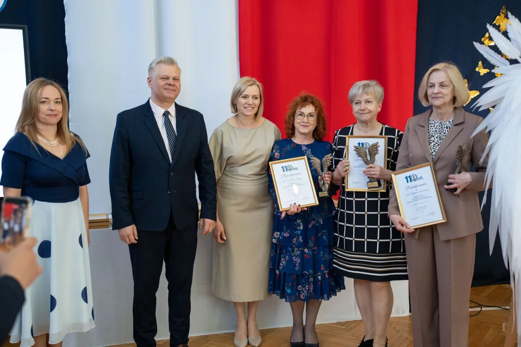 Występ artystyczny uczniów podczas oficjalnej akademii z okazji 110-lecia SP 2 w Skierniewicach, na scenie baner jubileuszowy.